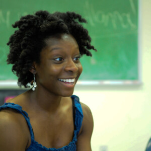 Alanna is a black woman wearing a blue shirt.