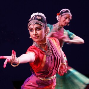 Ragamala Dance is a female duo wearing red and green dresses.