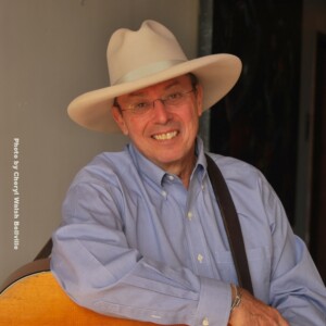 Charlie is a white male wearing a blue shirt and white cowboy hat.