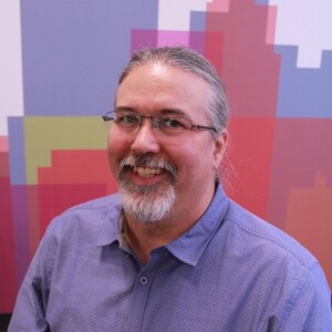 Kevin is a white male wearing a purple shirt.