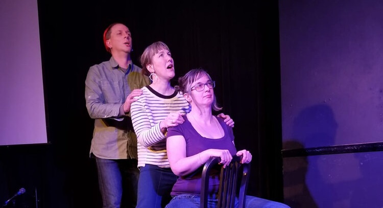 Jen is on stage with two other performers.