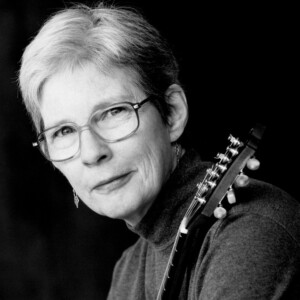 Joan is a white female wearing a gray shirt.