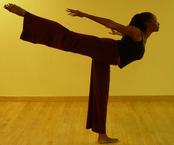Karla is a black female wearing a black shirt and purple pants.