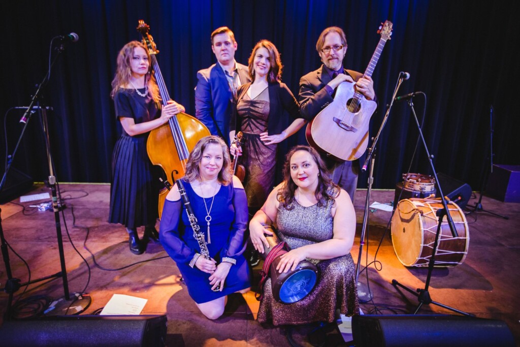 OrkestarBezlme is a 6-person group of male and females holding instruments.