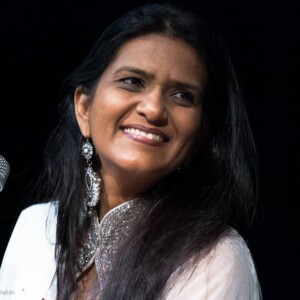 Pooja is an Indian female wearing a white dress.