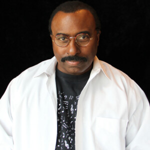 Soli is a black male wearing a black shirt under a white shirt.