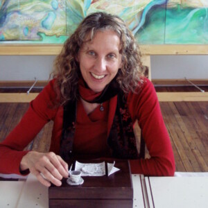 Susan is a white female wearing a red shirt.