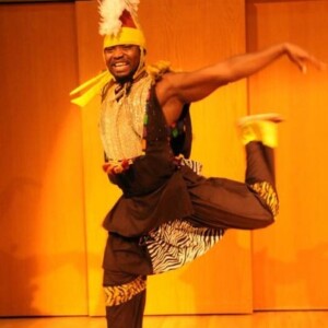 Christian is a black man wearing a cultural outfit.