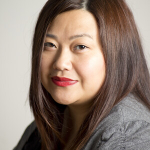 May is an Asian female wearing a gray shirt.