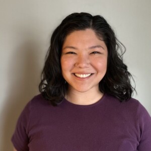 Pauline is a South American female wearing a red shirt.