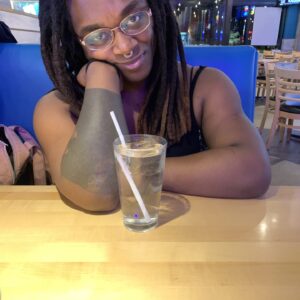 Taiwana is a Black female wearing a black shirt.