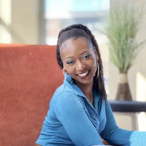 Dralanda is a Black female wearing a blue shirt.